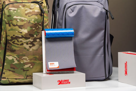 Shows Atlas ONE fabrics including PFAS free recycled fabrics including MultiCam, EcoPak, UltraGrid and RBC